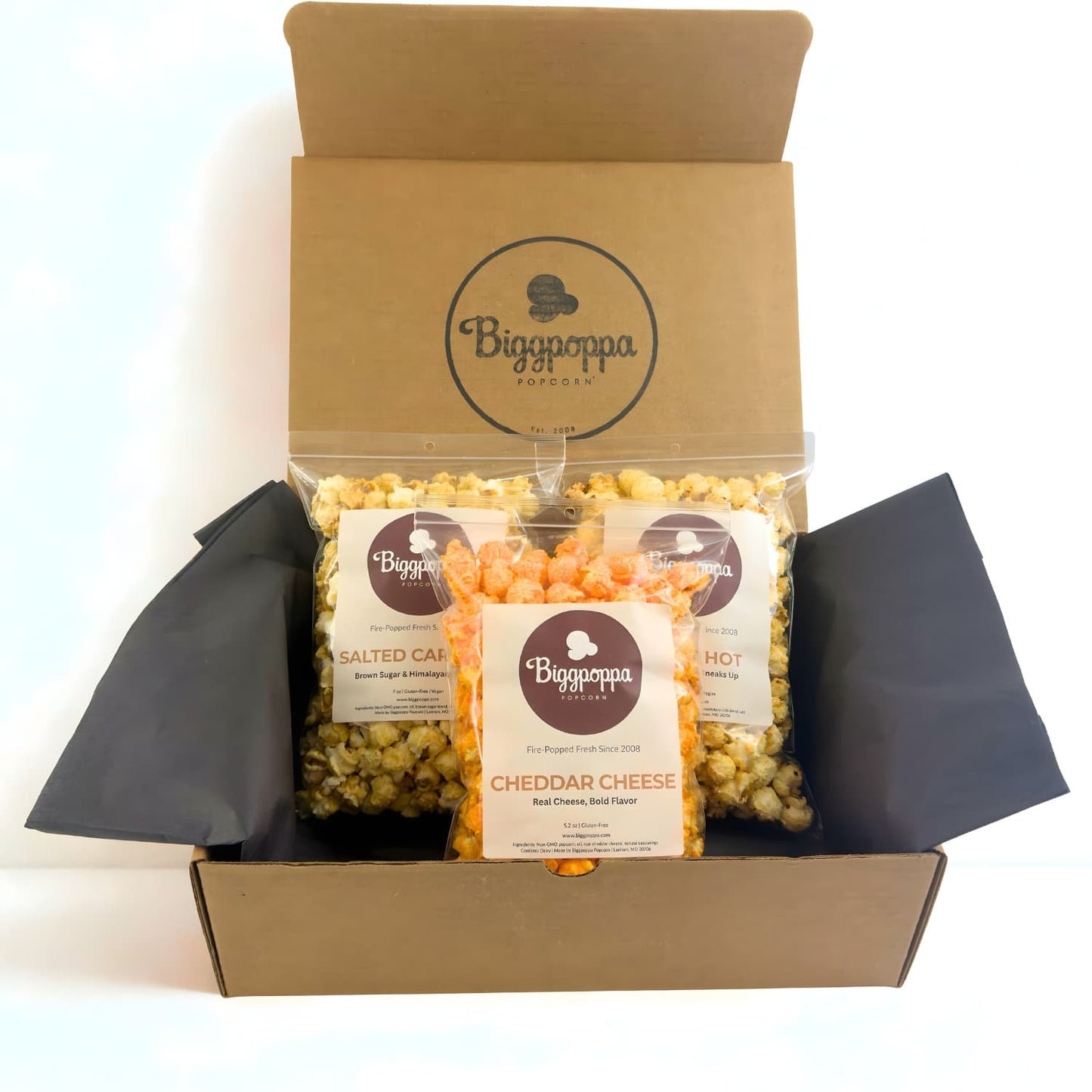 Biggpoppa Popcorn packaging with three share size bags of gourmet popcorn in a rustic kraft box.
