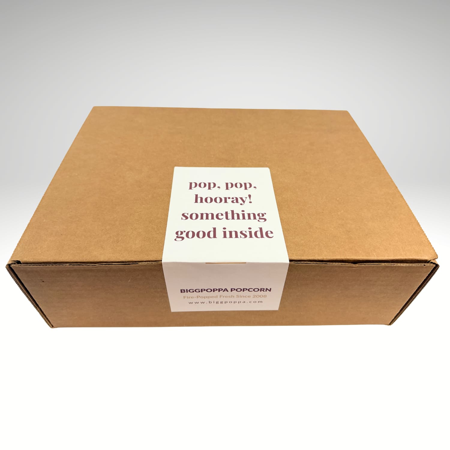 Kraft box with a white label on a light gray background