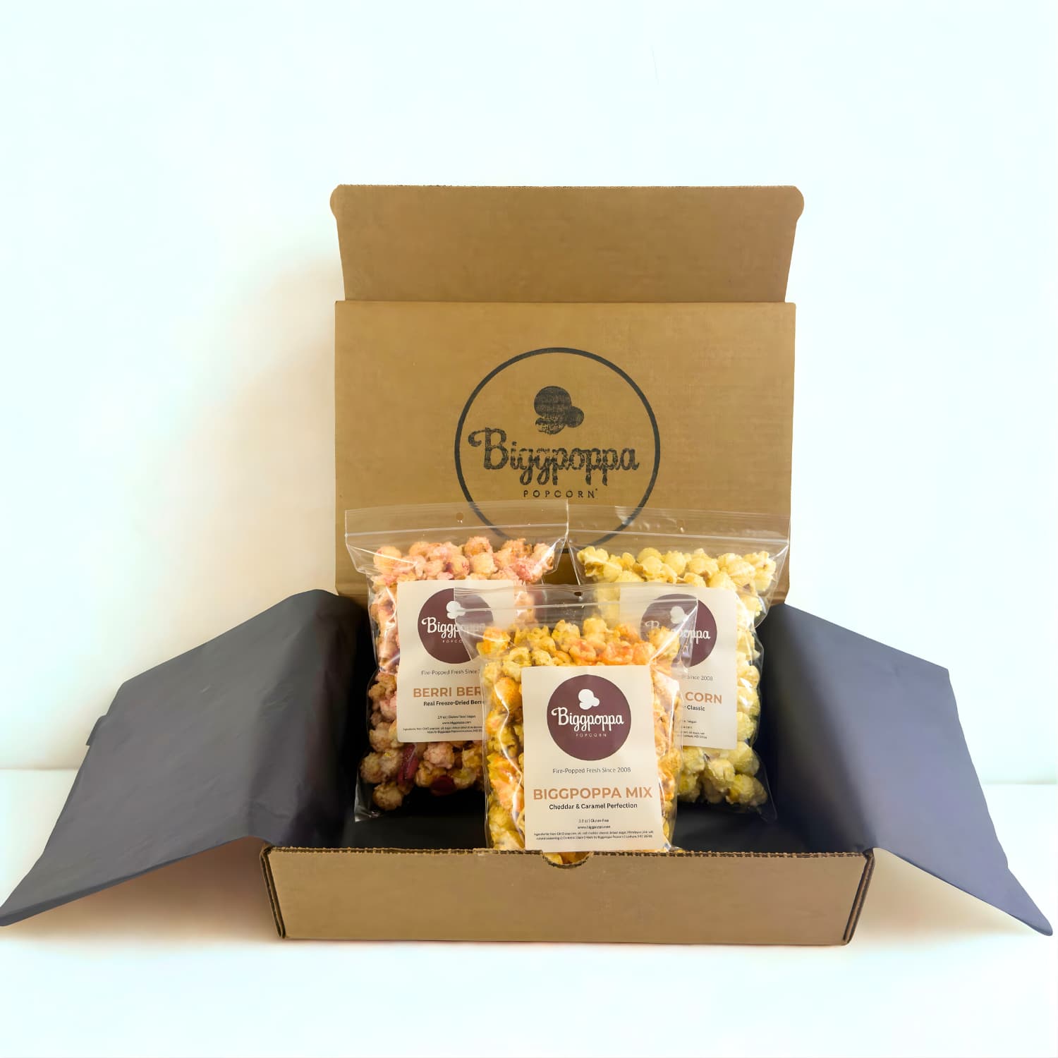 Box of Biggpoppa Popcorn with three snack size bags of popcorn inside