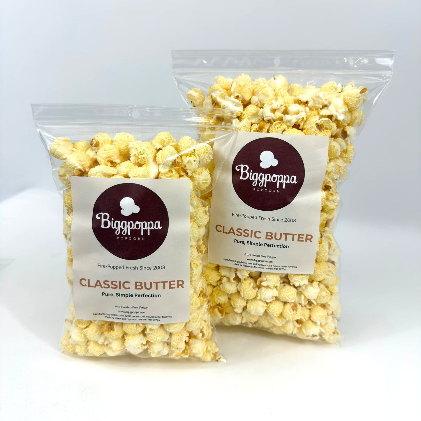 Two bags of Biggoppa Classic Butter popcorn on a white background