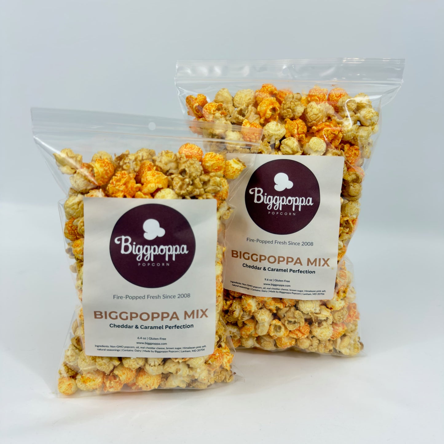 Two bags of Biggpoppa Mix popcorn on a white background