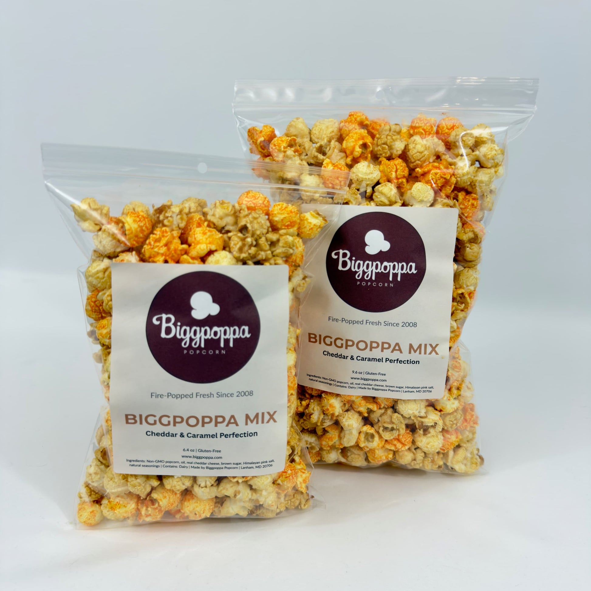 Two bags of Biggpoppa Mix popcorn on a white background