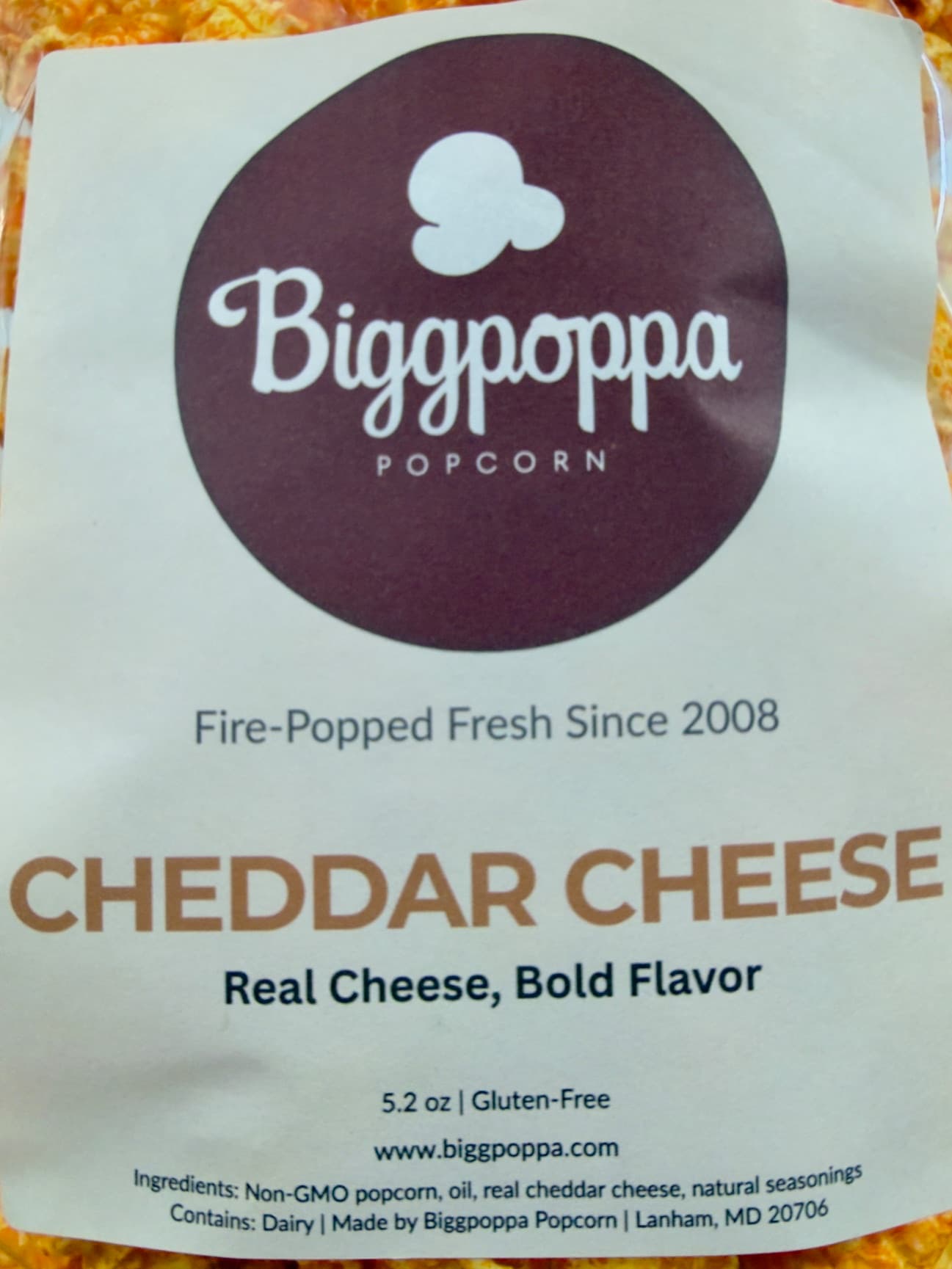 Cheddar Cheese packaging with Biggpoppa Popcorn branding and product details.