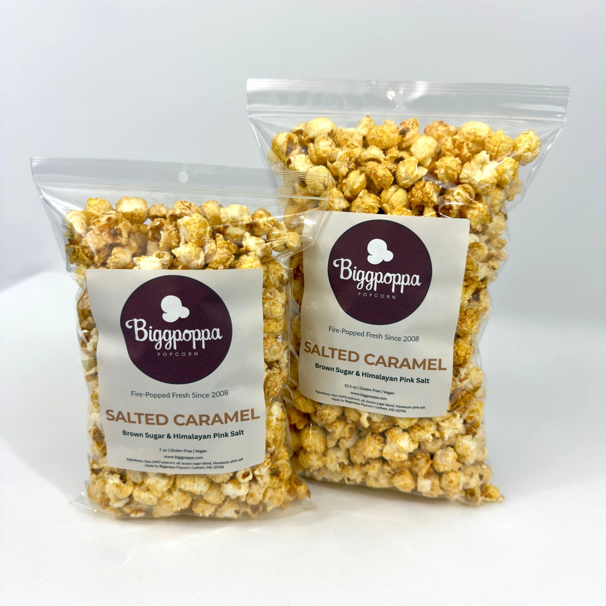 Two bags of Biggoppa Salted Caramel popcorn on a white background